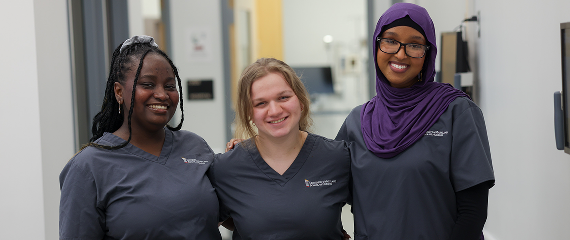 Three students of different ethnicities pose together