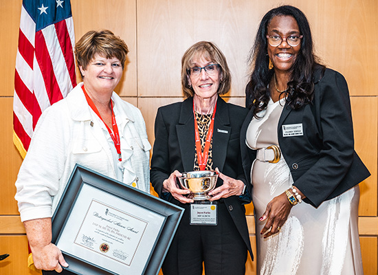 Tracie Schwoyer-Morgan and Yolanda Ogbolu presenting Joyce Parks with the distinguished alumni award