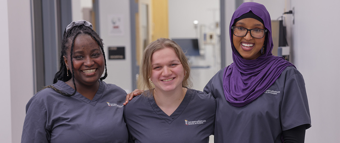 three female nursing students pose in a hospital