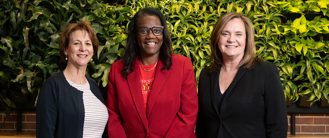 Yolanda Ogbolu of UMSON stands in the middle, with Karen Doyle of UMMC on her left and Peggy Norton-Rosko on her right